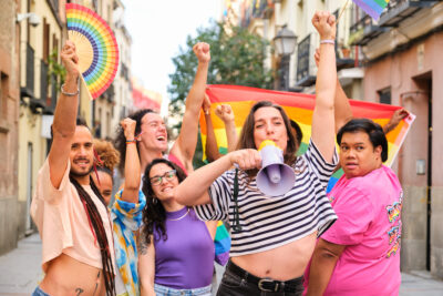 lgbtq people with rainbow flags and a megaphone fi 2024 04 02 21 05 49 utc