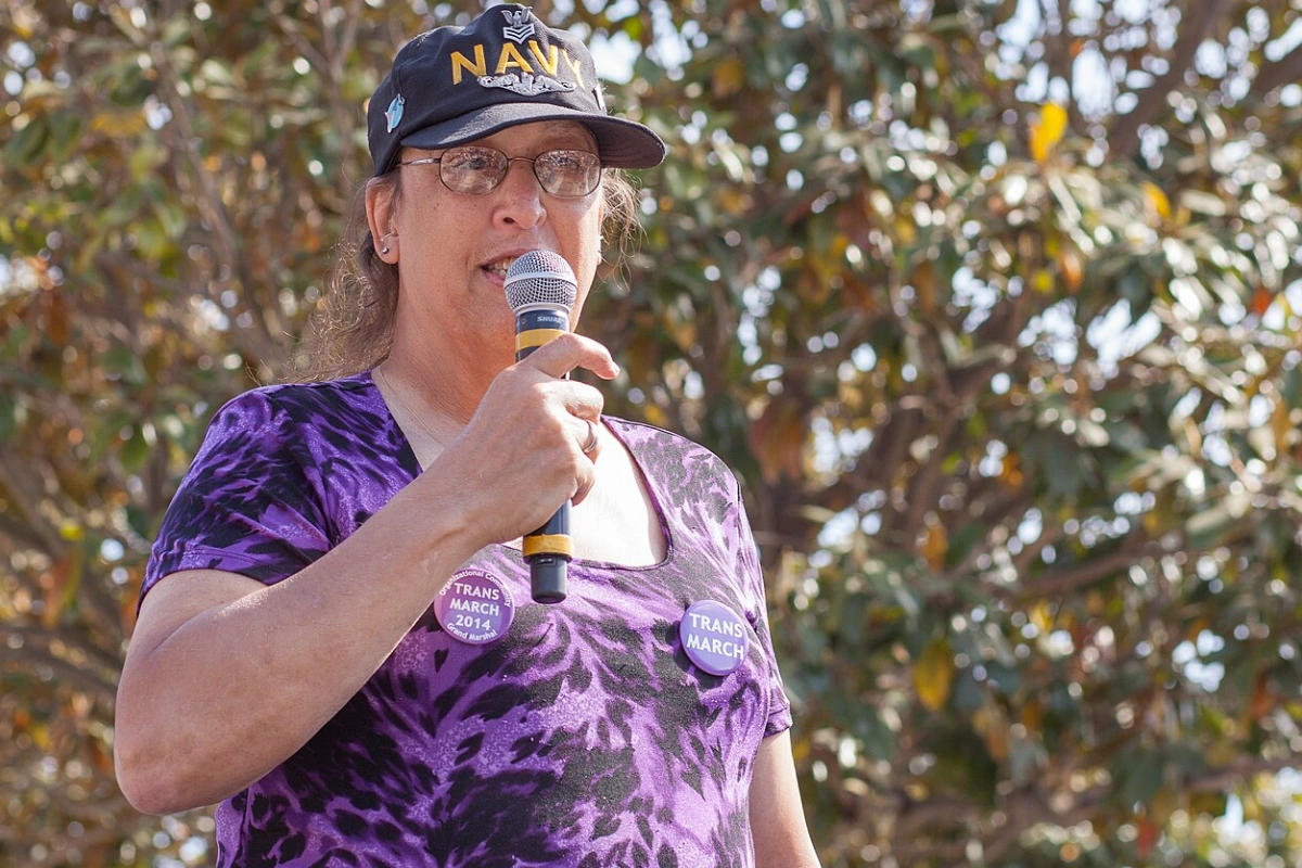 Transgender Flag: Colours, Meaning and History 13 Monica Helms at Trans March 2014 wearing a Navy cap and talking into a microphone while giving a speech.