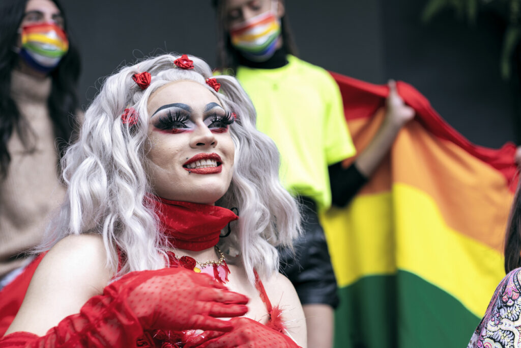 Drag queen smiles as she enjoys her day celebrating gay pride with all her friends.