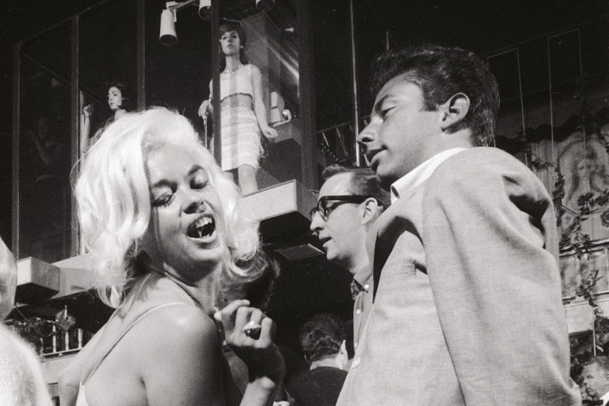 What Is a Gogo Boy? What Male Gogo Dancers Actually Do 14 Jayne Mansfield is photographed dancing inside of Whisky a Go Go, with female go go dancers behind on a platformed stage