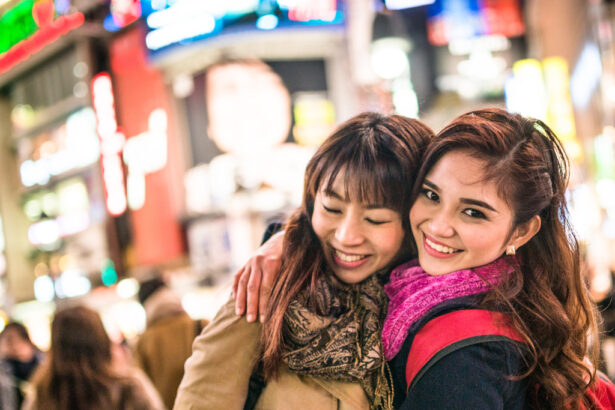 two women hugging in a bright street