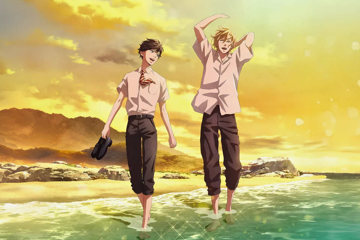 Two male students walk barefoot through shallow seawater at sunset, smiling together against a golden coastal landscape.