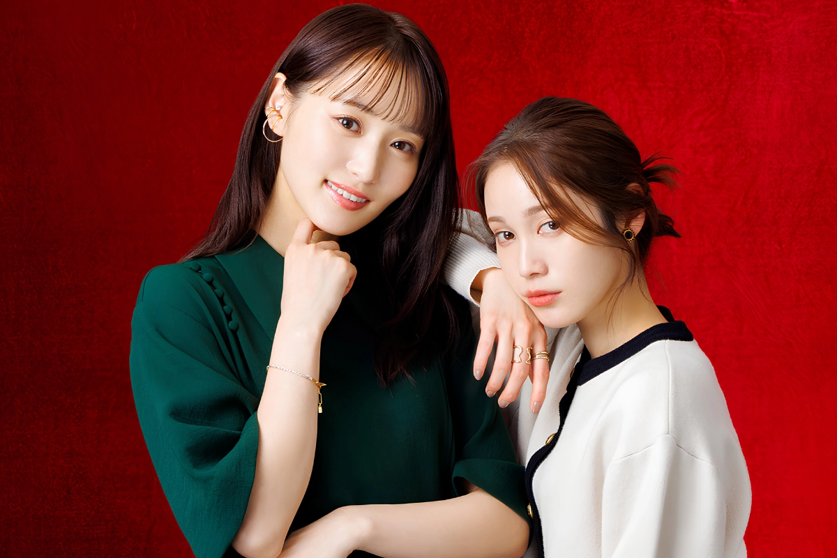 10 Best Japanese Lesbian Movies & Series to Watch 19 Two women posing closely together against a vivid red background.