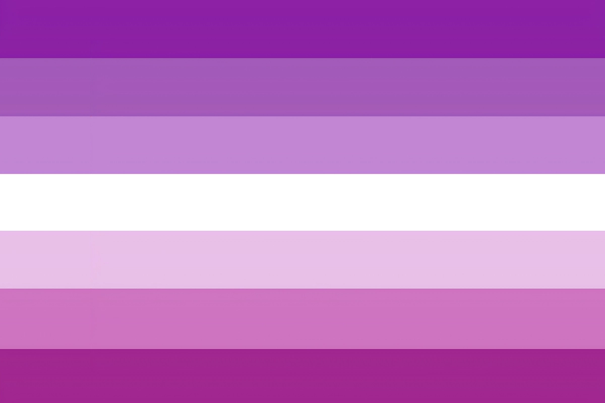 Seven-stripe femme pride flag in shades of purple, lavender, white, pale pink, pink, and deep magenta.