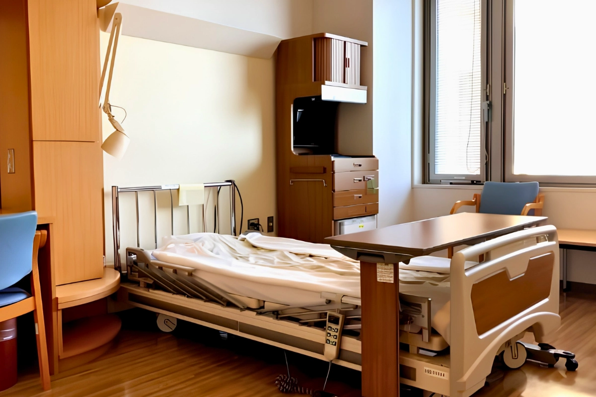 Getting Gender-Affirming Surgery in Japan: Providers, Costs and Preparation 15 Empty private hospital room with an adjustable bed, overbed table, chair, television, and large window.