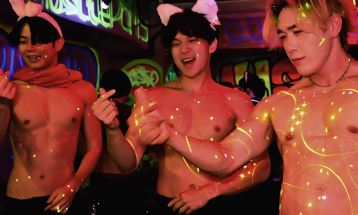 Three shirtless muscular performers entertain guests under colorful lights inside a Japanese muscle bar.