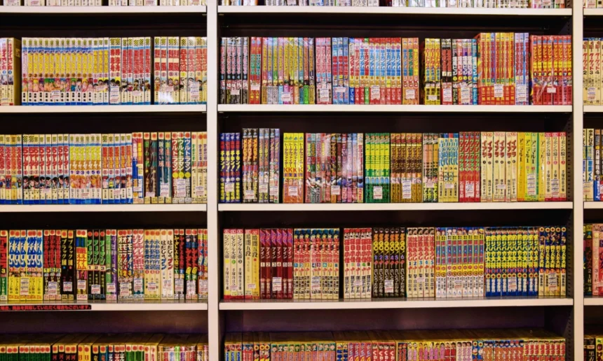 Rows of Japanese manga displayed on colorful bookstore shelves.