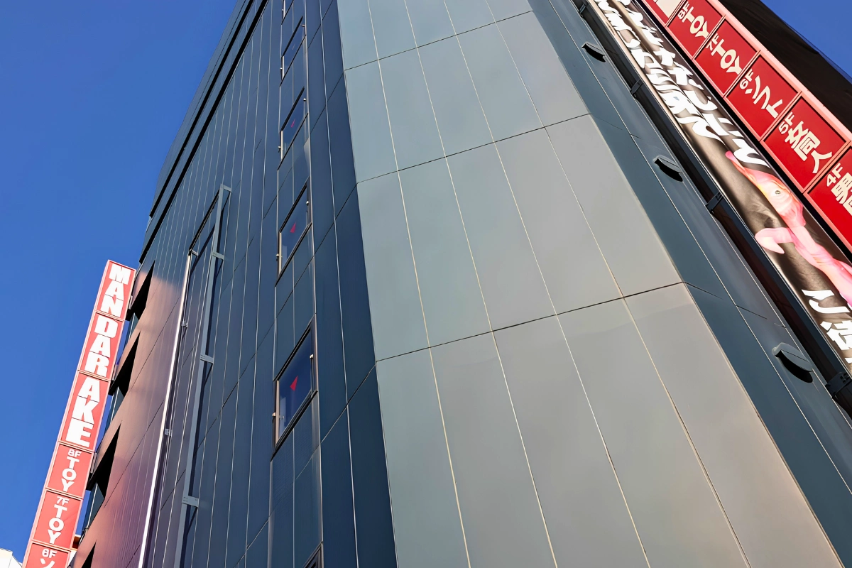 Where to Buy Yaoi/BL & Bara Manga in Japan 19 Exterior of a Mandarake store in Tokyo, with a tall red Mandarake sign running down the side of the building.