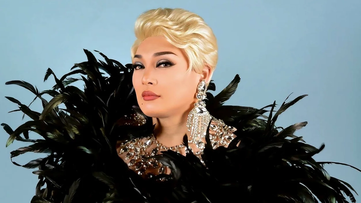 What Does Onee (オネエ) Mean in Japanese? 13 Drag queen staring into the camera with glamorous makeup and diamond jewellery, wearing featured outfit.