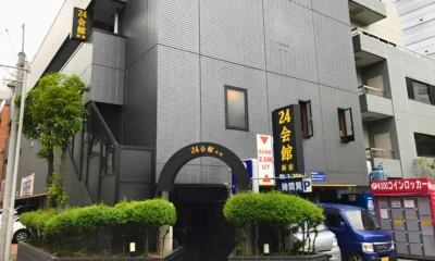 Exterior of 24 Kaikan Shinjuku, a multi-story building with the venue’s black-and-yellow signage above the entrance.