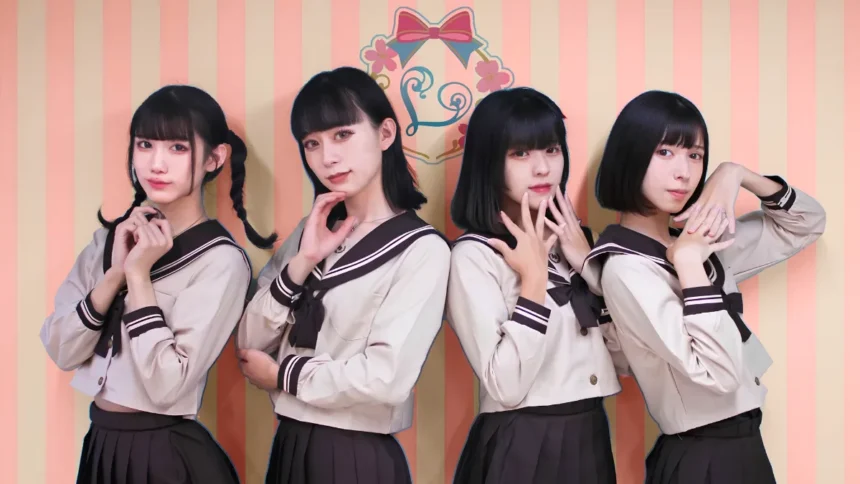 Four male maids dressed in matching uniform posing in front of a striped wall at a femboy cafe