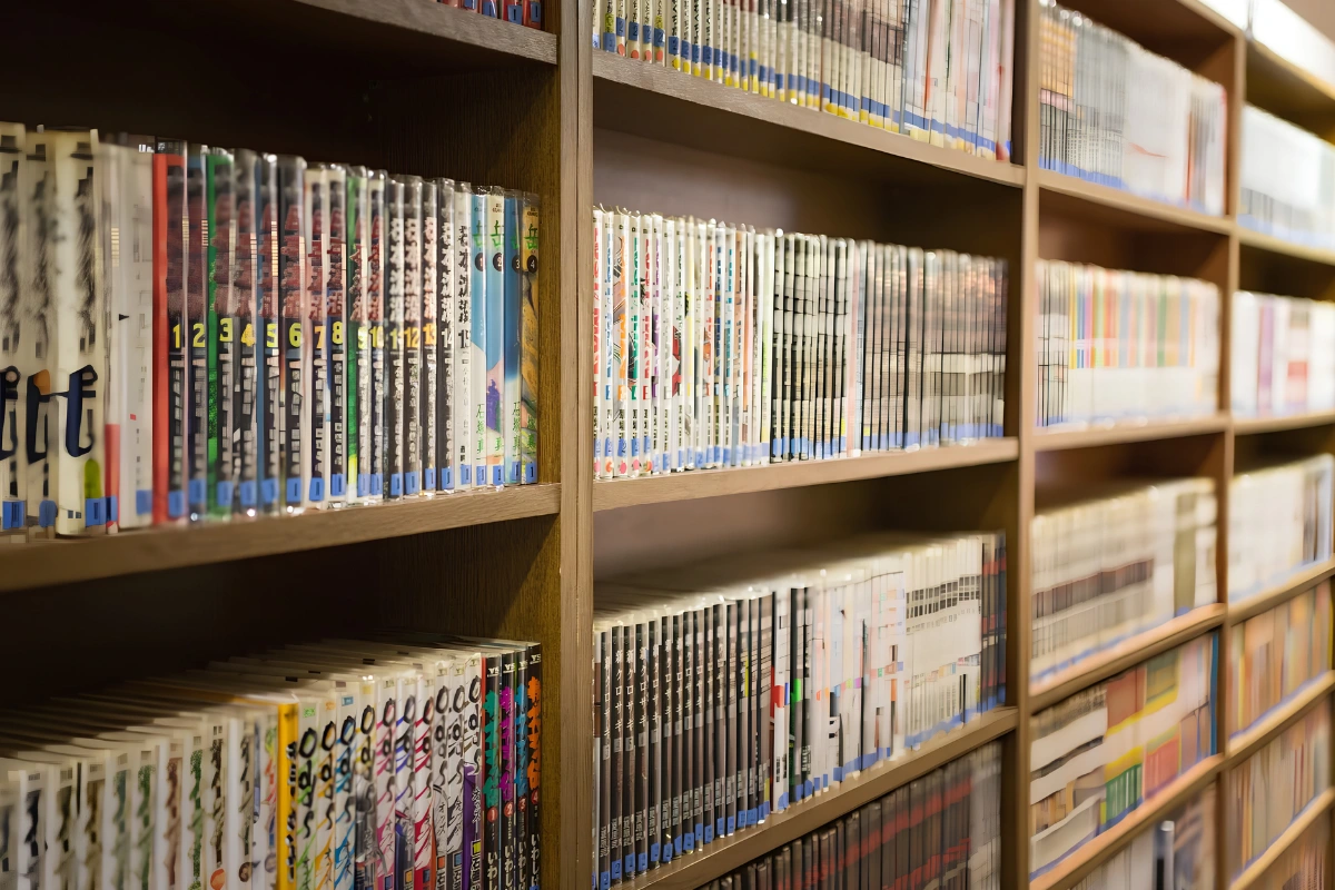 A bookstore with the shelves completely full of various manga all neatly ordered. 