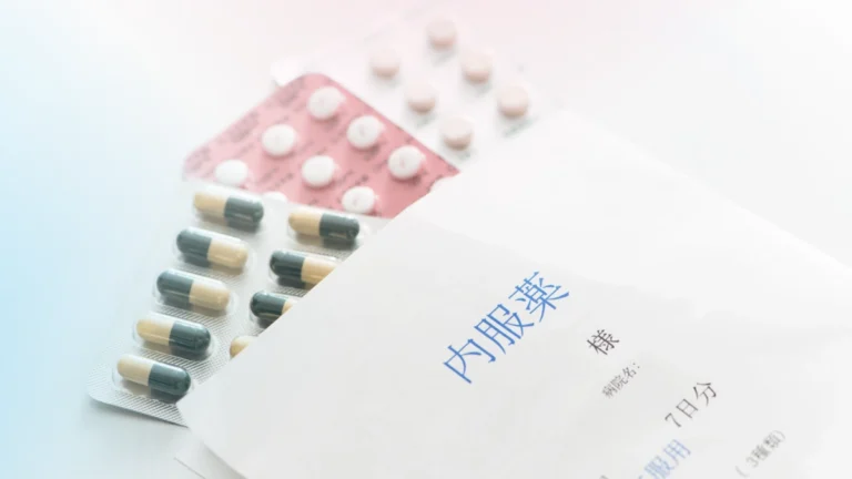 Hormone replacement therapy (HRT) medications, including prescription pills, next to a Japanese medication envelope.