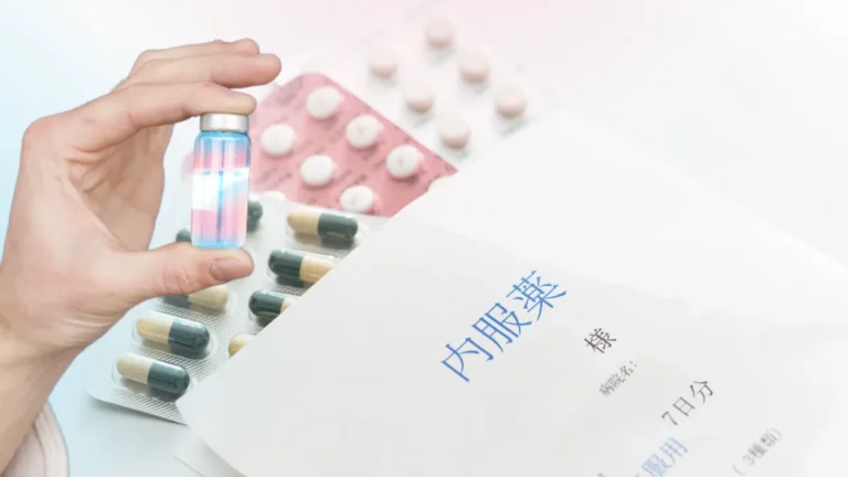 Hormone replacement therapy (HRT) medications, including a trans pride vial and prescription pills, next to a Japanese medication envelope.