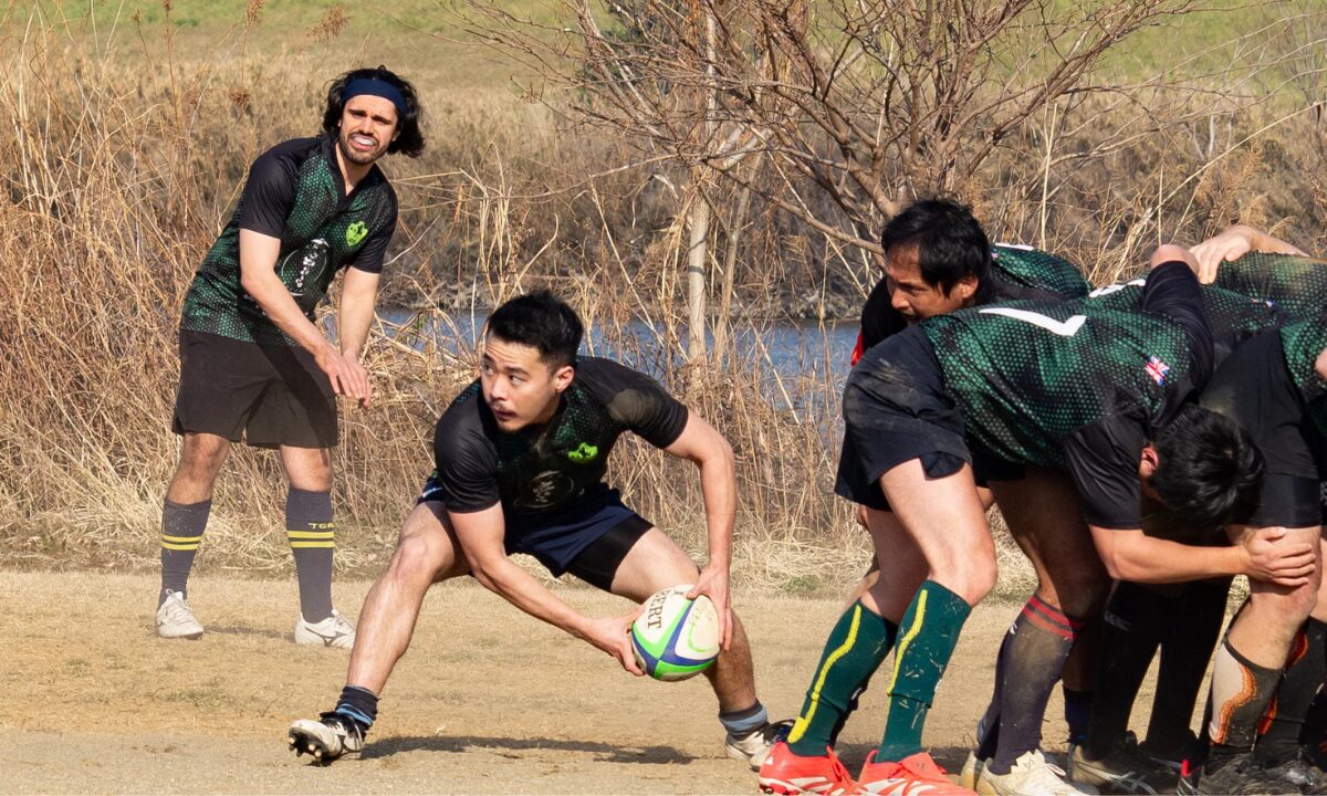 The Tsurumi Brats playing a game of rugby. A scrum-half is about to throw the ball.