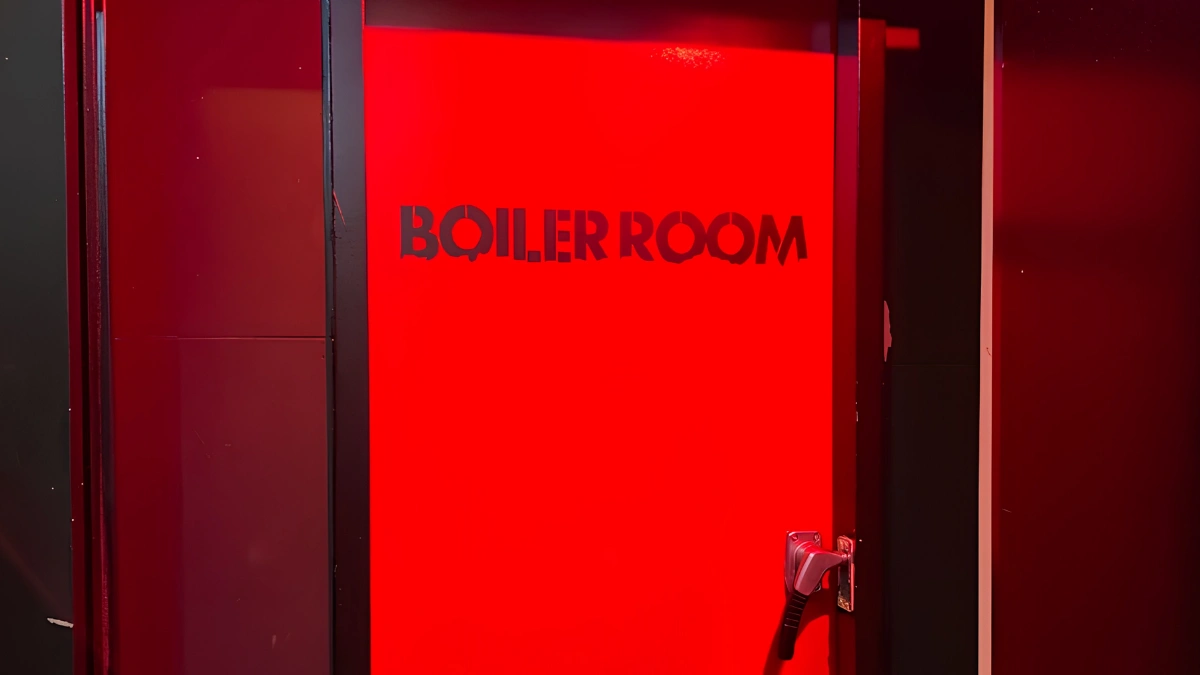 Image of red entrance door to Boiler Room.