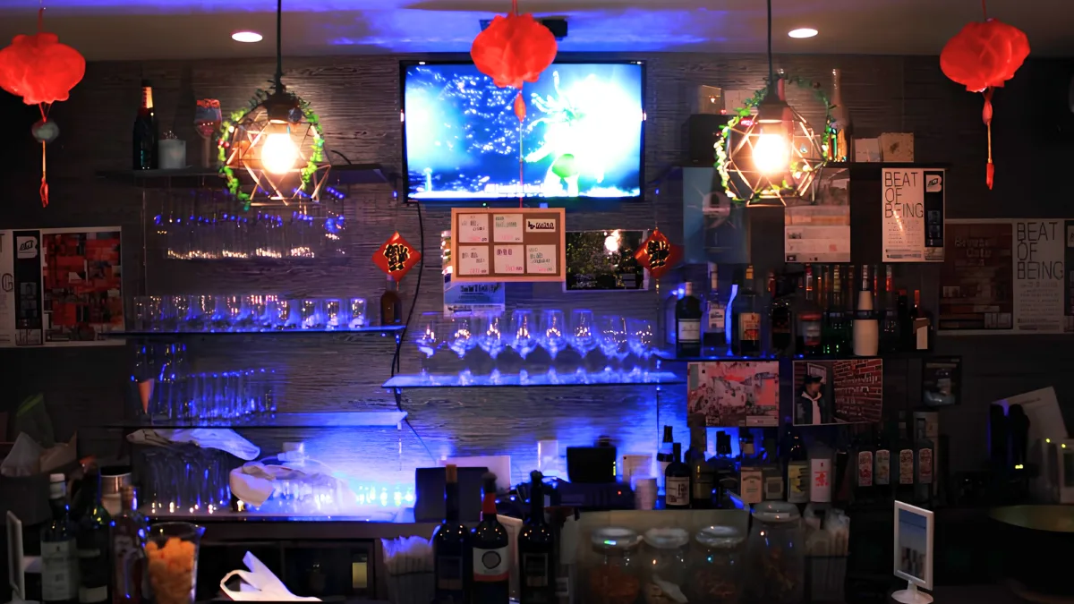 Image of bar at DUCKS! OSAKA with various glasses and bottles on display.