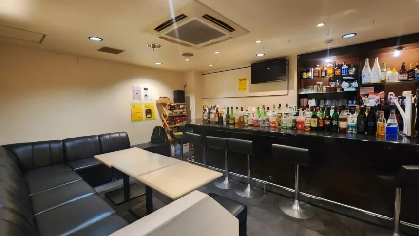 Image of inside of Lemon in Osaka. Image features bar area with seating, along with tables and sofas for more relaxed seating.