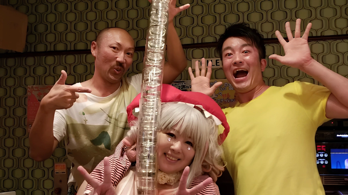 Image of staff waving to the camera inside of Panic House bar in Shinjuku Nichome.