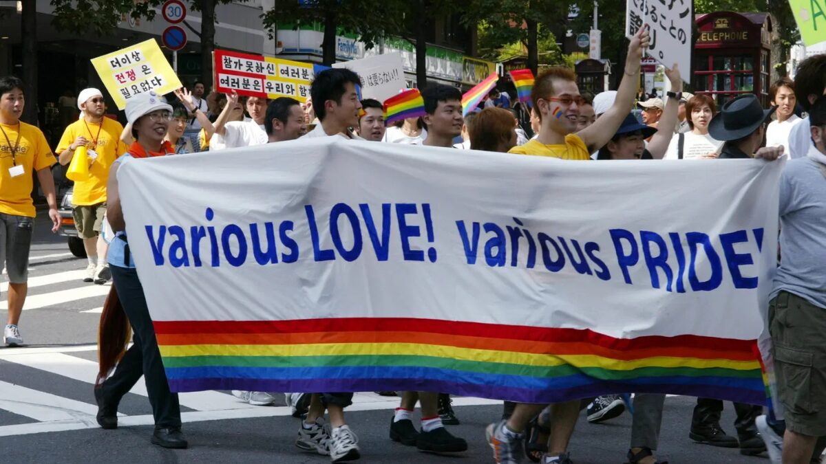 The History of Tokyo Pride: Protest, Party and Progress 14 Marchers at the 2002 Tokyo Lesbian and Gay Pride Parade walk with a banner reading “various LOVE! various PRIDE!” in English