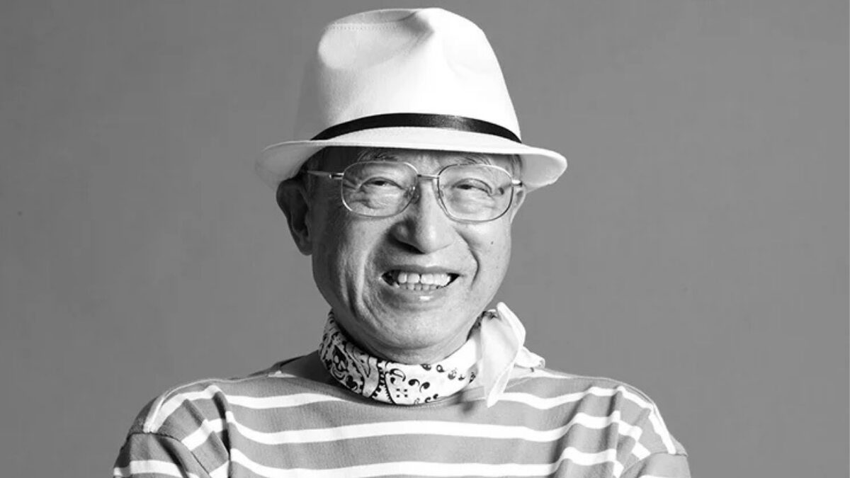 The History of Tokyo Pride: Protest, Party and Progress 12 Teishiro Minami wearing glasses, a white hat, and a t-shirt with horizontal stripes