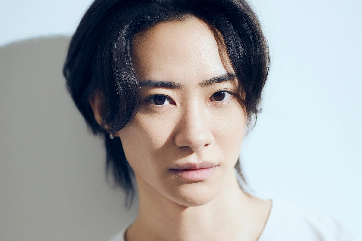 LGBTQ+ Japanese Celebrities to Know, From Pioneers to Today 29 Satsuki Nakayama looks into the camera in a serious manner as they wear a white t-shirt and small round earrings