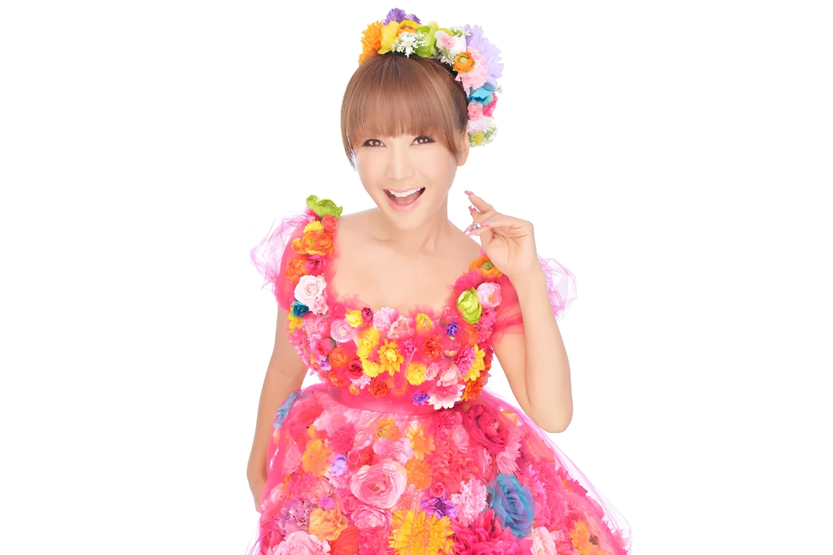 LGBTQ+ Japanese Celebrities to Know, From Pioneers to Today 22 Ai Haruna is posing and staring into the camera against a white backdrop, wearing a fun pink dress, covered in many flowers