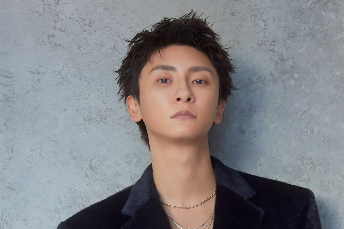 LGBTQ+ Japanese Celebrities to Know, From Pioneers to Today 31 Shinjiro Atae wears a black jacket and silver jewellery as they stare into the camera in front of a grey concrete wall