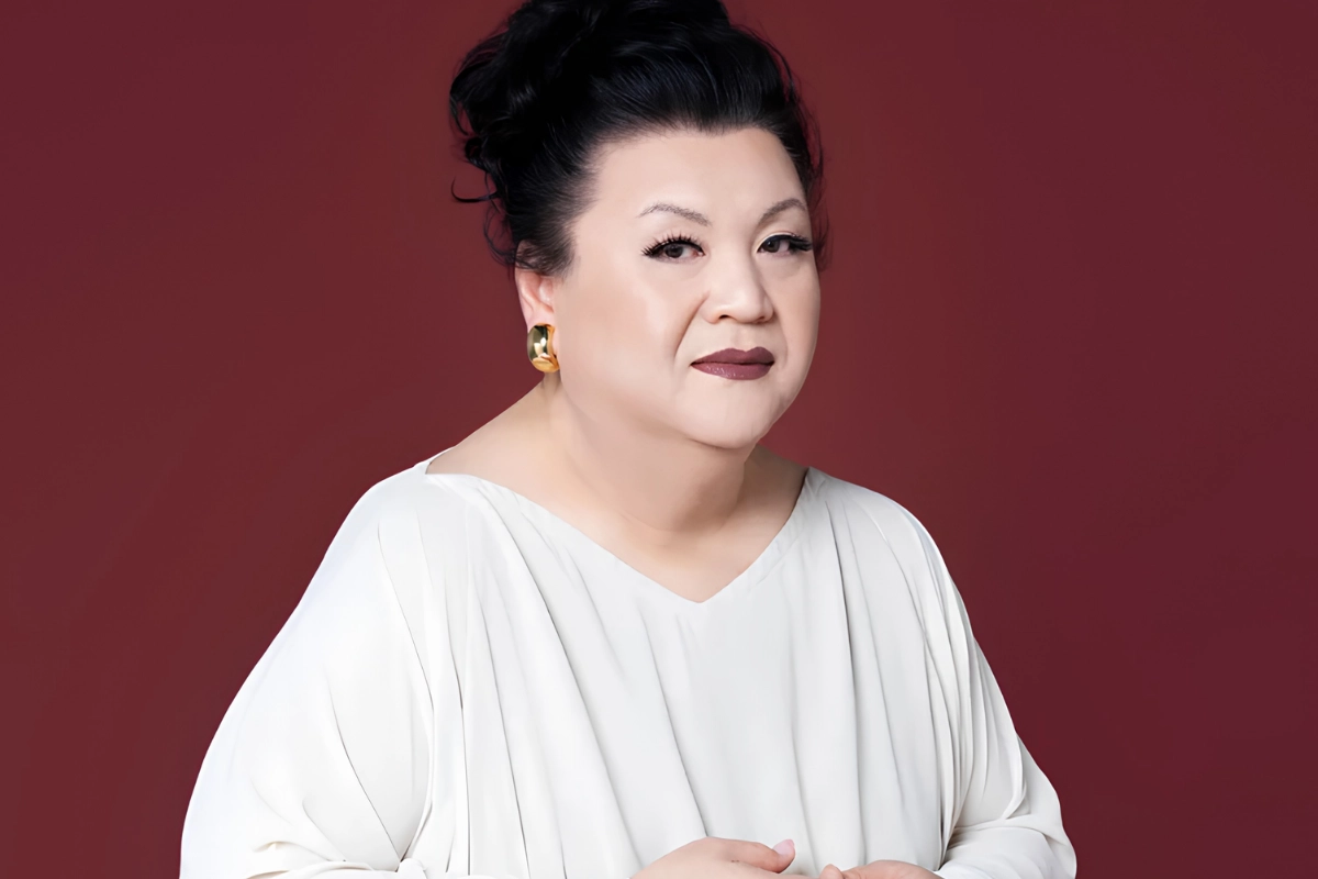 LGBTQ+ Japanese Celebrities to Know, From Pioneers to Today 20 Matsuko Deluxe poses in front of a maroon backdrop, wearing a while gown and dark red lipstick