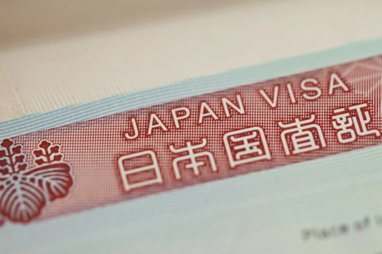 A Japanese visa documented with the kanji below and official emblem to the left