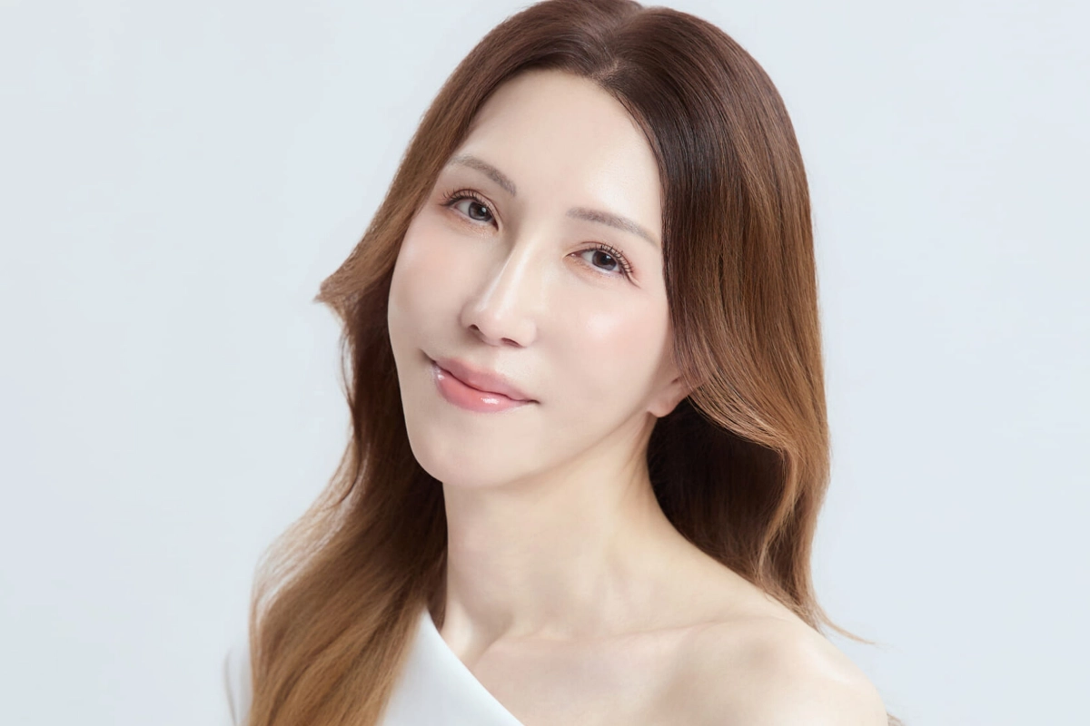 LGBTQ+ Japanese Celebrities to Know, From Pioneers to Today 19 KABA.chan is seen sat at an angle with their head turned towards the camera, while wearing their long hair down and in a white top