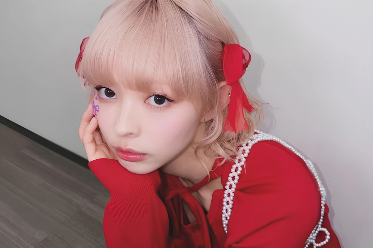 LGBTQ+ Japanese Celebrities to Know, From Pioneers to Today 27 Moga Mogami is crouching down as they pose for a picture wearing a red dress with pearl accessories, and a bow tie glitter sticker under their eye